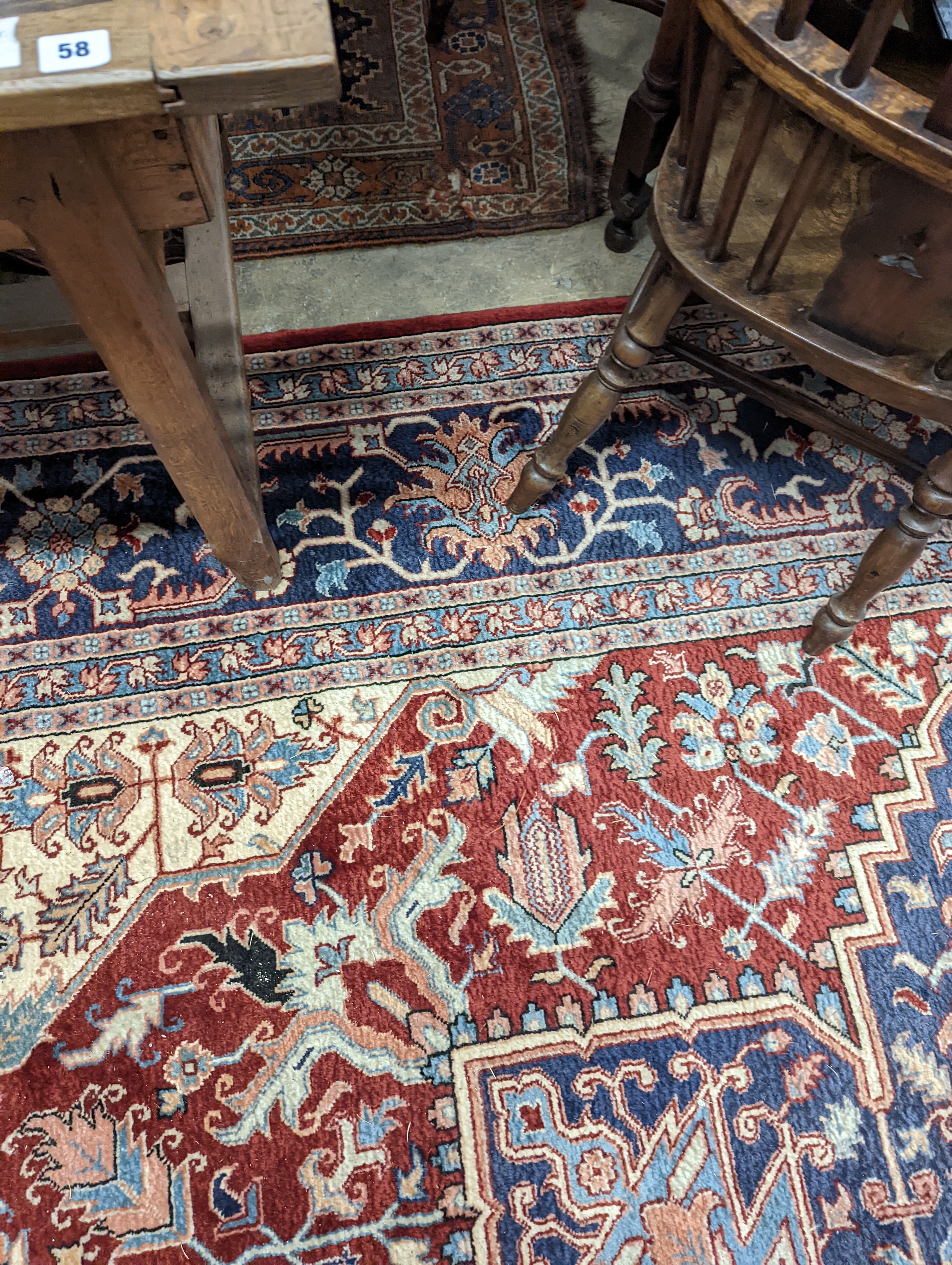 A large Caucasian style red ground carpet, 460 x 330cm